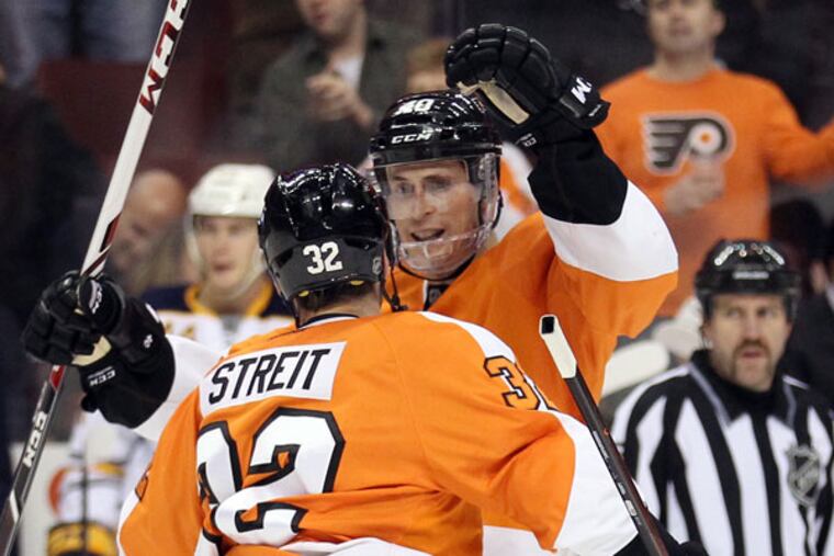 Vincent Lecavalier celebrates his third period goal with Mark Streit. (Yong Kim/Staff Photographer)