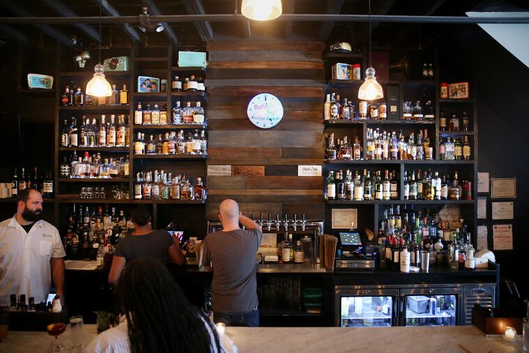 Bottles of whiskey sit behind the bar at Ripplewood Whiskey & Craft in Ardmore.