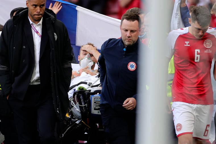 Paramedics using a stretcher to take out of the pitch Denmark's Christian Eriksen after he collapsed during the Euro 2020 soccer championship group B match between Denmark and Finland at Parken stadium in Copenhagen, Denmark, on Saturday.