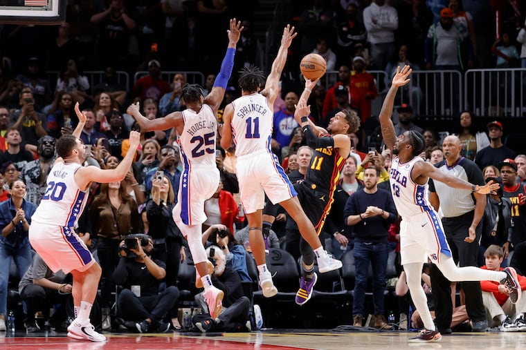 Trae Young shoots against 76ers guard Jaden Springer during the second half on April 7 in Atlanta.
