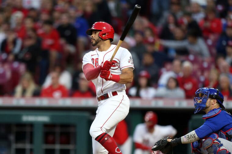 Cincinnati Reds' Tommy Pham, left, watches his home run in front of Chicago Cubs catcher Yan Gomes during the sixth inning of a baseball game in Cincinnati on Monday.
