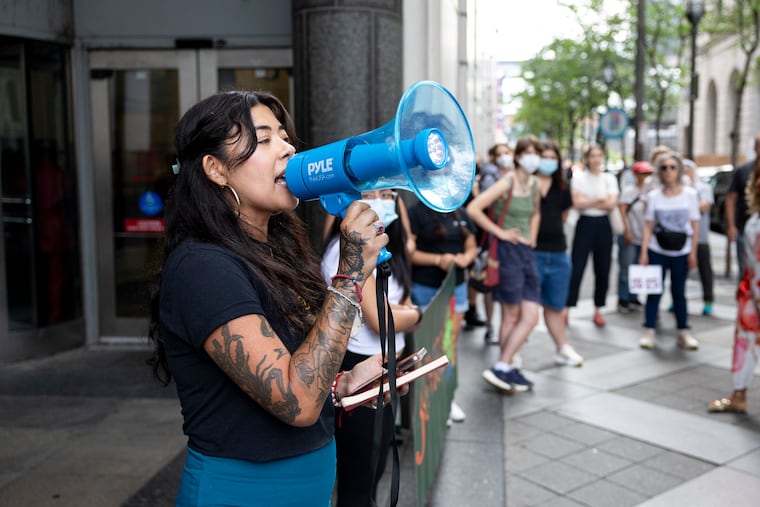 Erika Guadalupe, executive director at Juntos, leads the rally outside the Juanita Kidd Stout Center for Criminal Justice over ICE arrests on Friday.