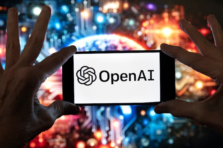 FILE - The OpenAI logo is displayed on a cell phone in front of an image generated by ChatGPT's Dall-E text-to-image model, Dec. 8, 2023, in Boston.