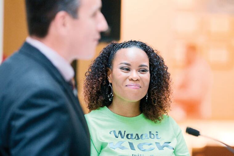 Meneko Spigner McBeth receives a certificate, which named the central court of the Deptford Mall after her for the day. Andrew Thayer / Staff Photographer