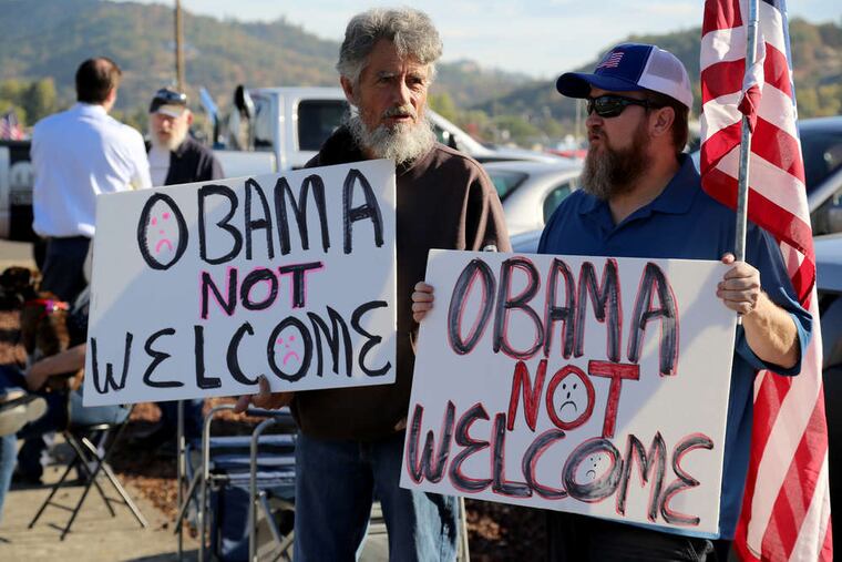 Gun-rights activists and others were out in force Friday in Roseburg, Ore., awaiting the arrival of President Obama. He was in town to meet with victims' families after the killings at Umpqua Community College.