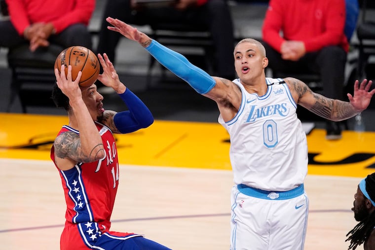 Sixers forward Danny Green (left) shoots as Los Angeles Lakers forward Kyle Kuzma defends during the first half Thursday night.