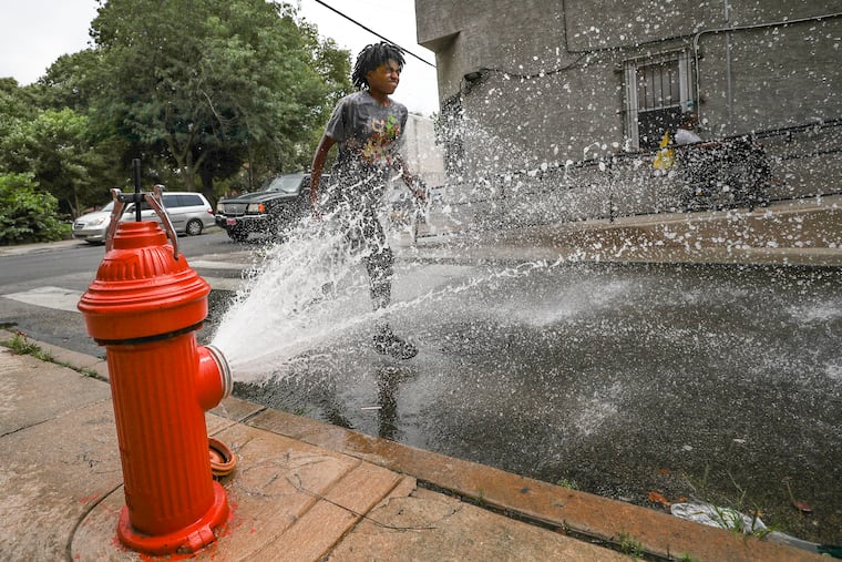 Nayomi Eldemire, 13, runs through an open hydrant off Huntingdon St. in North Philadelphia on July 27, 2023.
