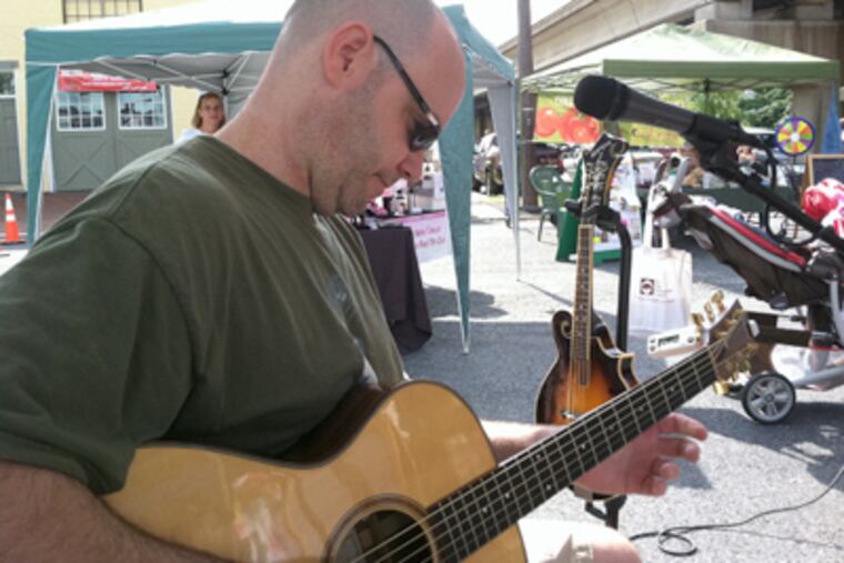 Troubadour Dave Kelly, 43, at the Collingswood Farmers' Market, one of his South Jersey venues.