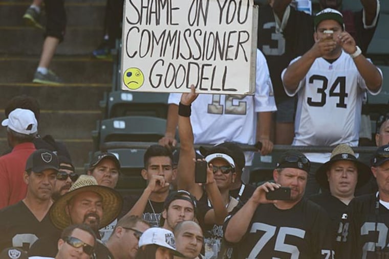 An Oakland Raiders fan holds a sign for NFL commissioner Roger Goodell after the game against the Houston Texans at O.co Coliseum. The Texans defeated the Raiders 30-14. (Kyle Terada/USA Today)