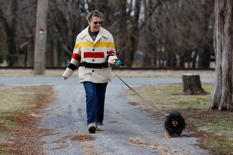 Breast cancer survivor Heather Klebon walks her dog, Faith, in her Clayton, Del., neighborhood on Jan. 27. Klebon was involved in the Penn Medicine proton radiation treatment for her breast cancer and has been cancer free for the last two and half years.