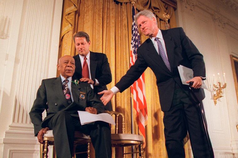 President Clinton and Vice President Al Gore, back, help Herman Shaw, 94, a Tuskegee Syphilis Study victim, during a news conference on May 16, 1997. Fifty years after the infamous Tuskegee syphilis study was revealed to the public in 1972 and halted, Manhattan-based philanthropy organization Milbank Memorial Fund is publicly apologizing for its role in the infamous Tuskegee syphilis study.