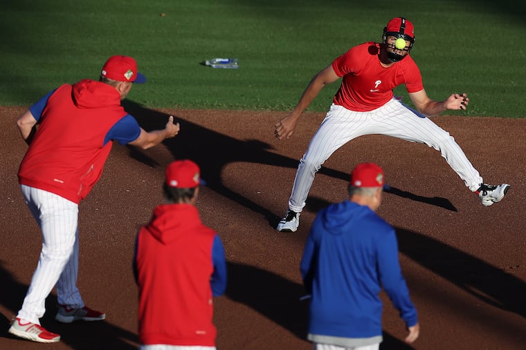 Phillies shortstop Trea Turner takes part in a drill that involved bouncing a tennis ball off a softball mask during a spring training workout on Tuesday in Clearwater, Fla.