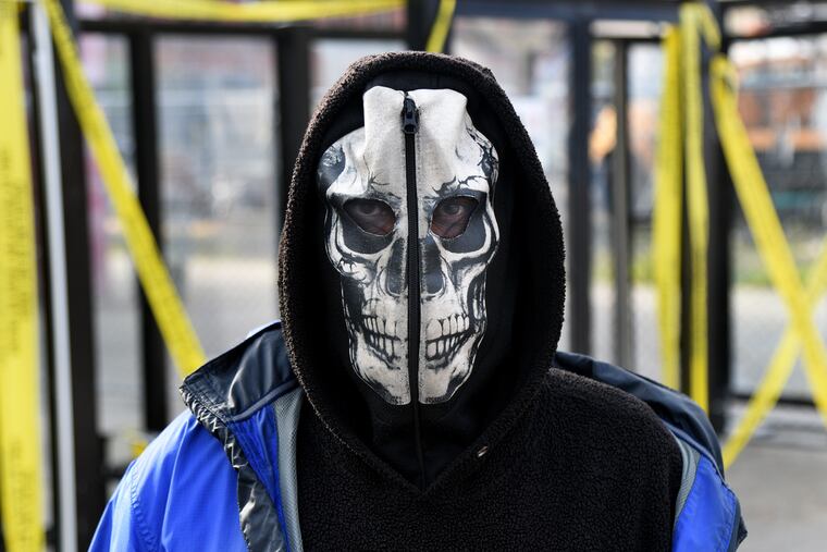 April 27, 2020: A NJ Transit bus rider wears a full face mask as he waits at the Walter Rand Transportation Center in Camden.