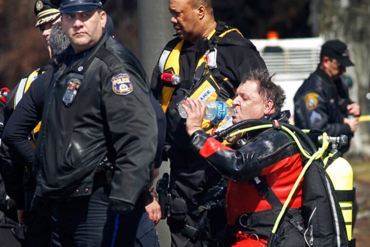 The rescue diver that went into the Schuylkill River drinks water after diving going into water to remove victim of motor vehicle accident out of submerged car. Philadelphia Marine Unit officers with police department and Fire Department were called to a report of a man in the Schuylkill River on Tuesday, March 19, 2013. Rescue diver removed one male victim from the water. ( ALEJANDRO A. ALVAREZ / STAFF PHOTOGRAPHER )