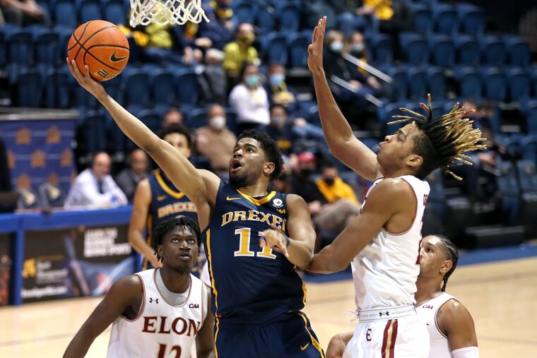 Drexel's Camren Wynter (11) scores against Elon's Michael Graham (right) during the second half on Jan. 20, 2022.