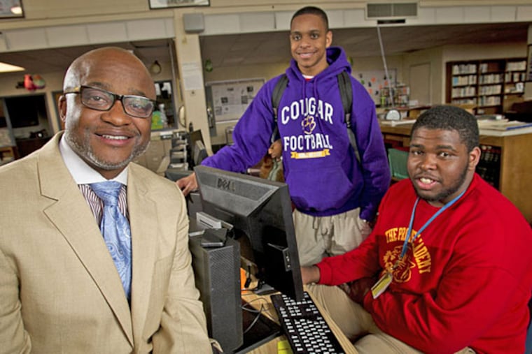 Martin Luther King principal William Wade with Emmanuel Clark (center) and Frank Darden, whose football team went from 1-10 to the Public League title after merger with Germantown High. (Alejandro A. Alvarez/Staff)