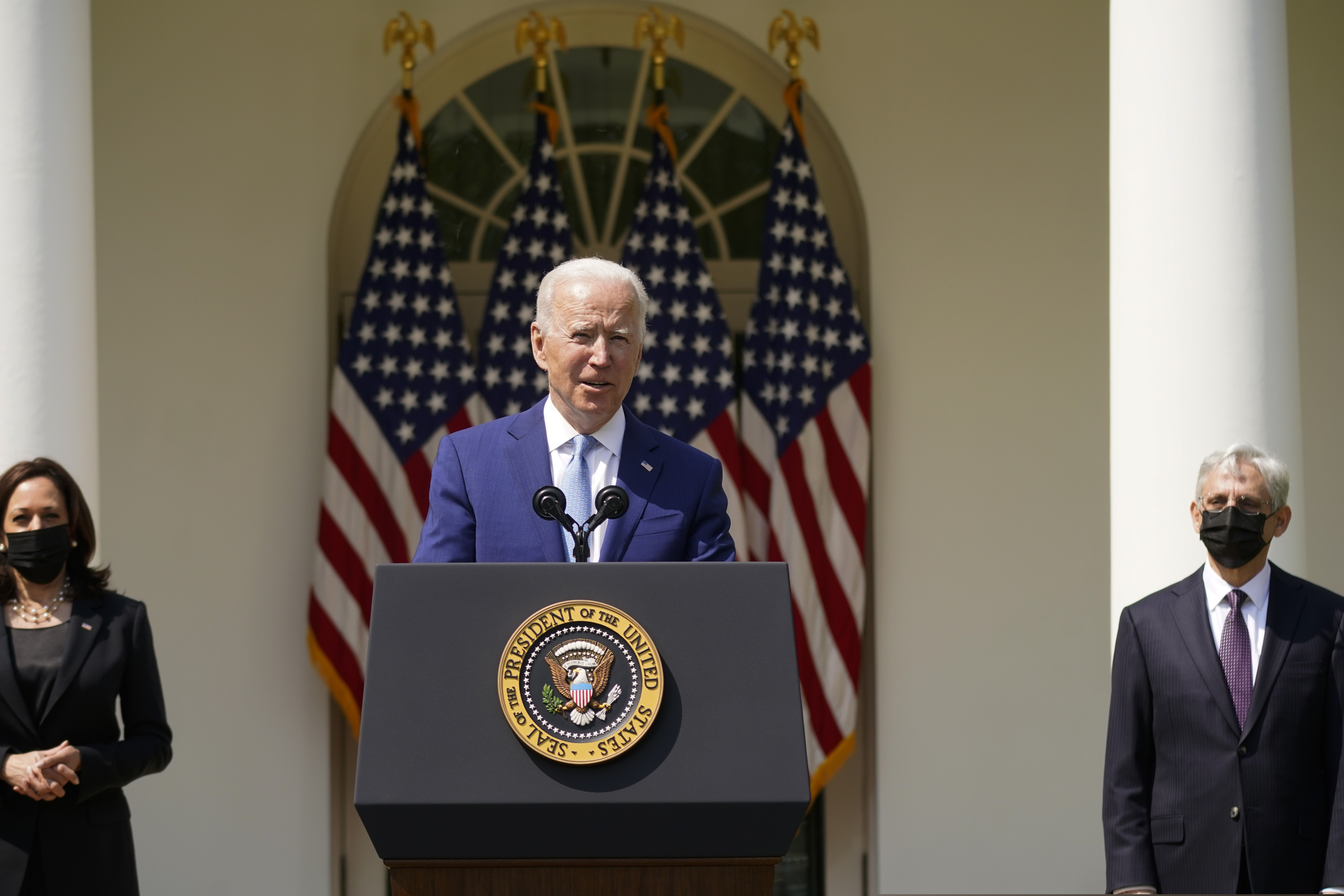 President Joe Biden, accompanied by Vice President Kamala Harris (left), and Attorney General Merrick Garland (right), speaks about gun violence prevention in the Rose Garden at the White House.