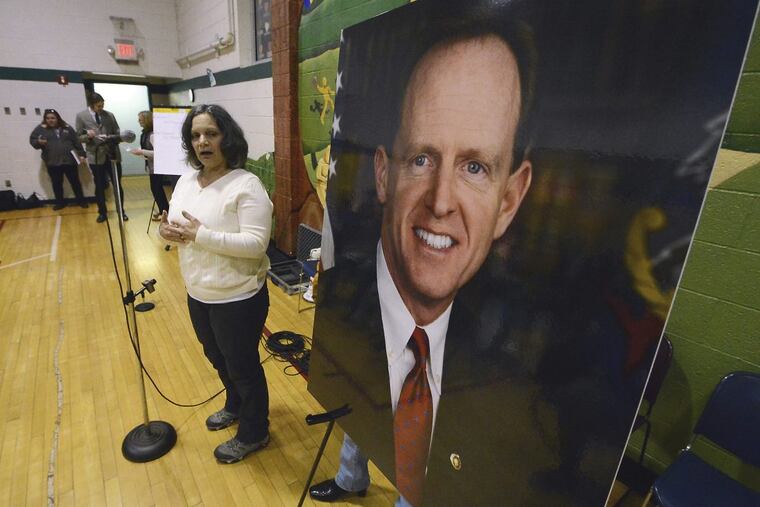 Anna Washick of Thornhurst, Pa., tells her story regarding health care next to a large photograph of Pennsylvania U.S. Senator Pat Toomey (R), who was invited to speak, but did not attend the meeting on Tuesday, Feb. 21, 2017, held at the United Neighborhood Center in Scranton, Pa. ( Butch Comegys / The Times & Tribune via AP) MANDATORY CREDIT