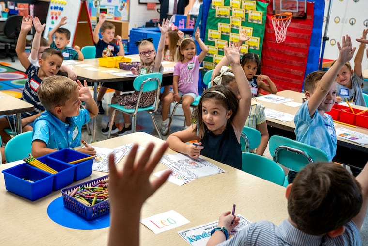 Students respond as Maureen Coller starts her 26th year as a kindergarten teacher in Cinnaminson, welcoming students Wednesday on the first day of school at the New Albany School.