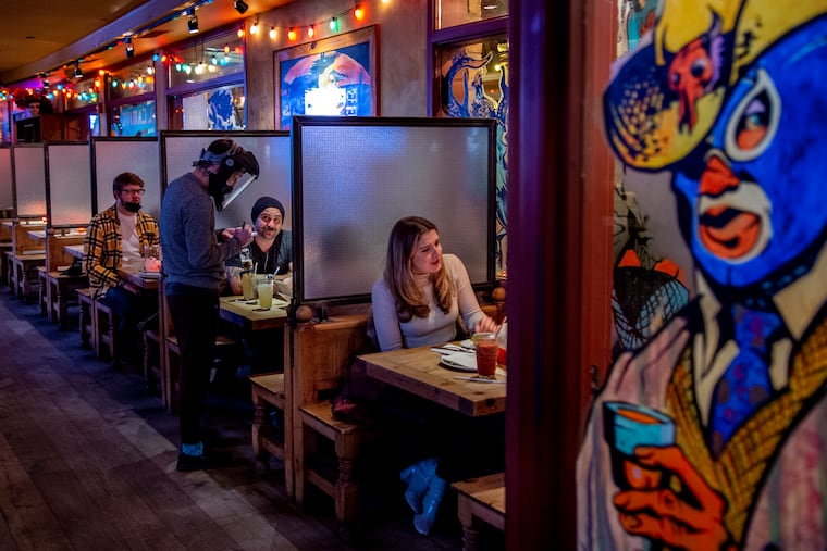 Waiter Tyler Waddle serves Gerard Gall and his party inside the El Camino Real Restaurant.