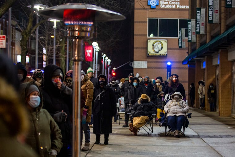 David Burke, (left) and his wife, Stephanie Burke, (right), have been sitting in line for almost 7 hours to receive the vaccination from Black Doctors COVID-19 Consortium 24 hour walk-in vaccination at the Temple Liacouras Center. “Right now there is no real way to get it unless you wait out and stay out in these lines,” David said. “It was the perfect opportunity. It’s good it ain't raining or snowing.”