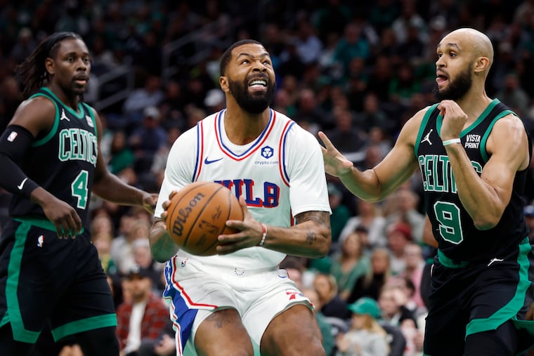 Philadelphia 76ers' Marcus Morris Sr. looks to shoot, between Boston Celtics' Jrue Holiday (4) and Derrick White (9) during the first half of an NBA basketball game Friday in Boston. (AP Photo/Michael Dwyer)