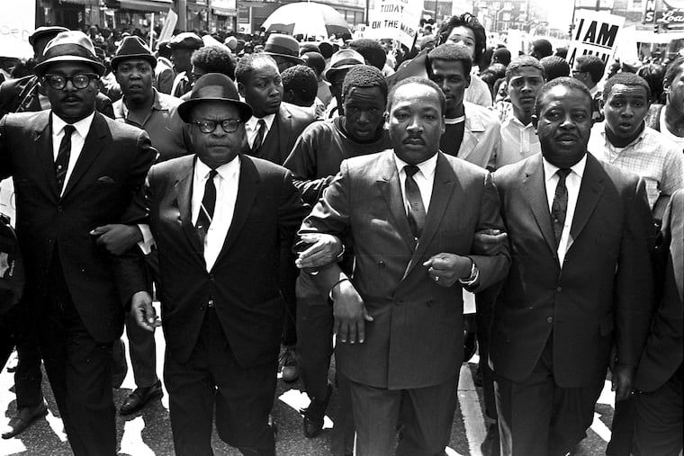 The Rev. Ralph Abernathy, right, and Bishop Julian Smith, left, flank Dr. Martin Luther King, Jr., during a civil rights march in Memphis, Tenn., March 28, 1968.
