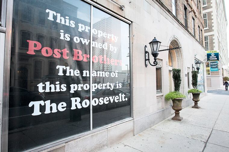 On a window at the Roosevelt Apartments, a notification of the ownership status.