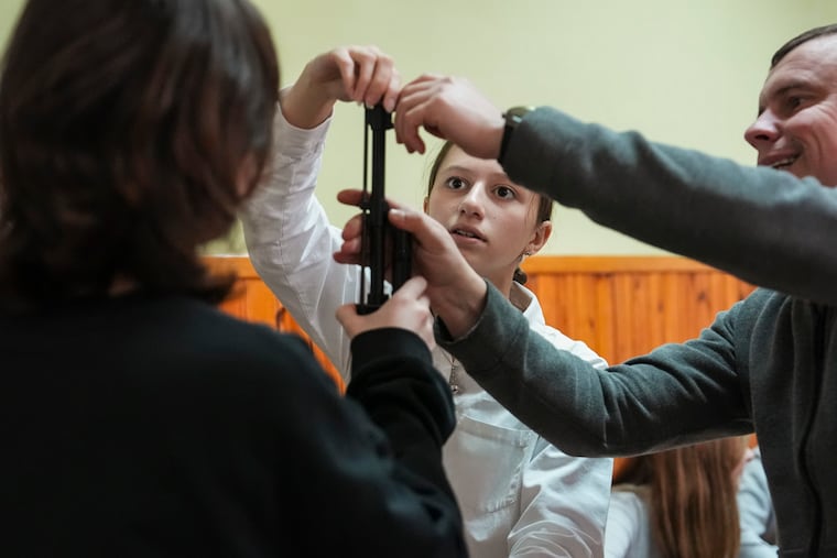 Katya Demchenkova learns to disassemble, clean, reassemble, and load guns.