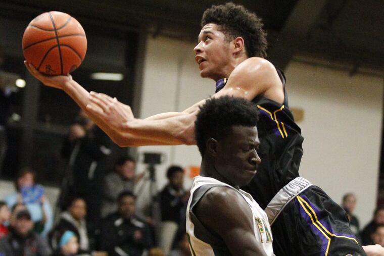 Roman Catholic’s Seth Lundy (top) collides with Bonner-Prendie’s Ajiri Johnson in a game last season.