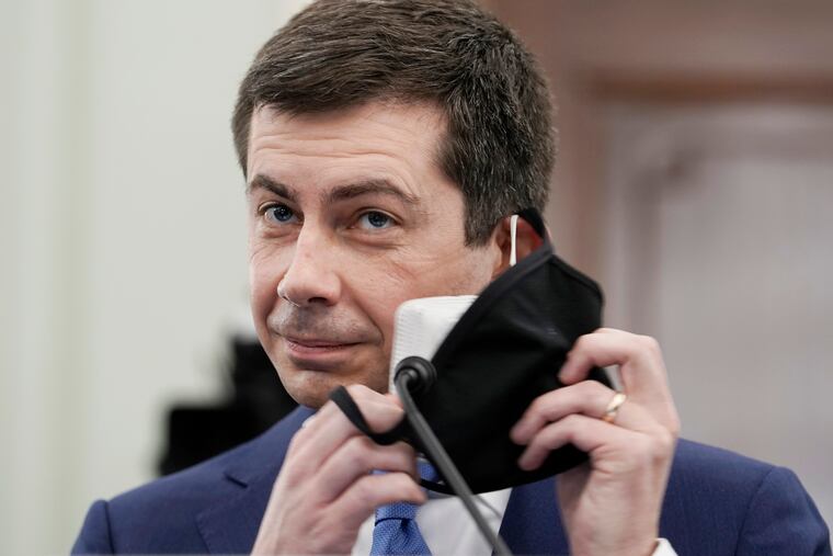Transportation Secretary nominee Pete Buttigieg removes both his face masks to speak during a Senate Commerce, Science and Transportation Committee confirmation hearing.