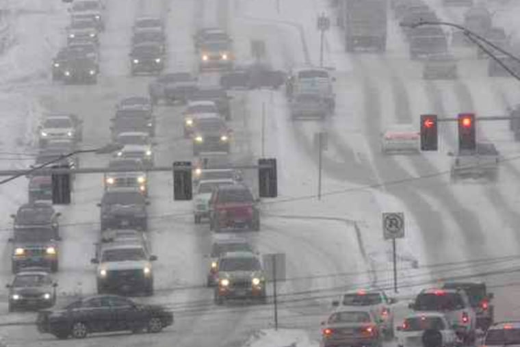 Vehicles creeping along in blizzard conditions on Dodge Street in Omaha, Neb. Forecasterssaid parts of Nebraska and several other states could expect continued snow through today.