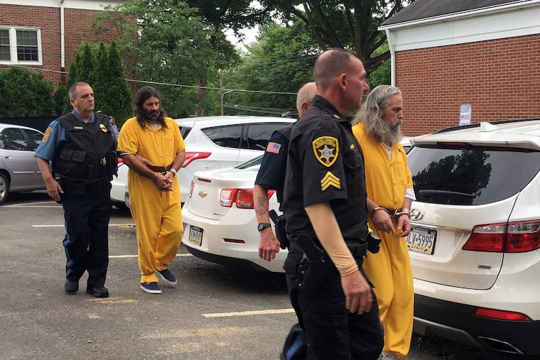 Daniel Stoltzfus (left in yellow) and Lee Kaplan (right in yellow) are led to a preliminary hearing Tuesday, Aug. 2, 2016, outside Bucks County Magisterial District Judge John I. Waltman's courtroom in Feasterville.