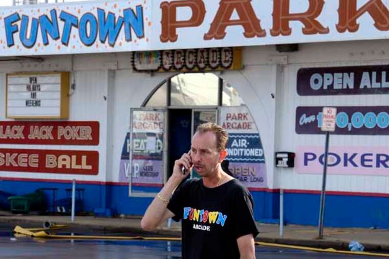 Daniel Shauger, manager of the Funtown Arcade, near his burned out business on the boardwalk in Seaside Park September 13, 2013, the day after a fire leveled four blocks just 10 months after the same area was devastated by Hurricane Sandy. ( TOM GRALISH / Staff Photographer )