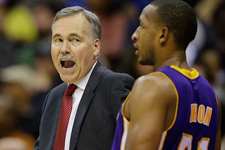 Los Angeles Lakers guard Kobe Bryant talks with a referee in the second half of an NBA basketball game against the Washington Wizards Friday, Dec. 14, 2012 in Washington. The Lakers won 102-96. (Alex Brandon/AP)