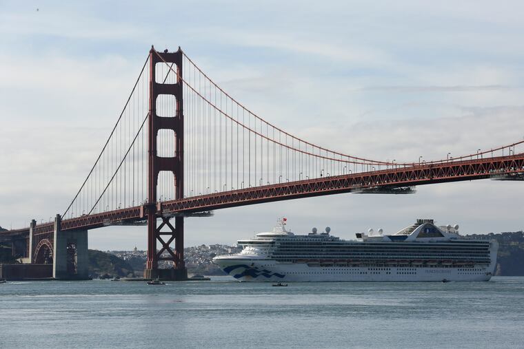 The Grand Princess cruise ship passes beneath the Golden Gate Bridge.