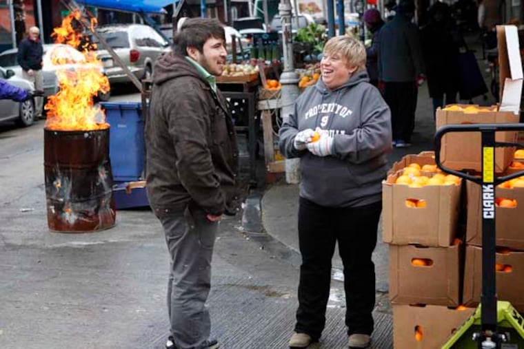 Michele Gambino (right), business manager, United Merchants of the South 9th Business Association, talks with merchant Jonathan Rivera (left) of Tortilleria San Roman. The Italian Market is now more the Italian-Mexican-Vietnamese Market. December 17, 2013.( MICHAEL S. WIRTZ / Staff Photographer )