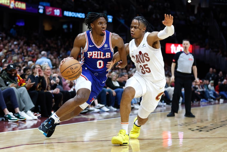 Tyrese Maxey of the Sixers driving against Cleveland Cavaliers forward Isaac Okoro on Friday.