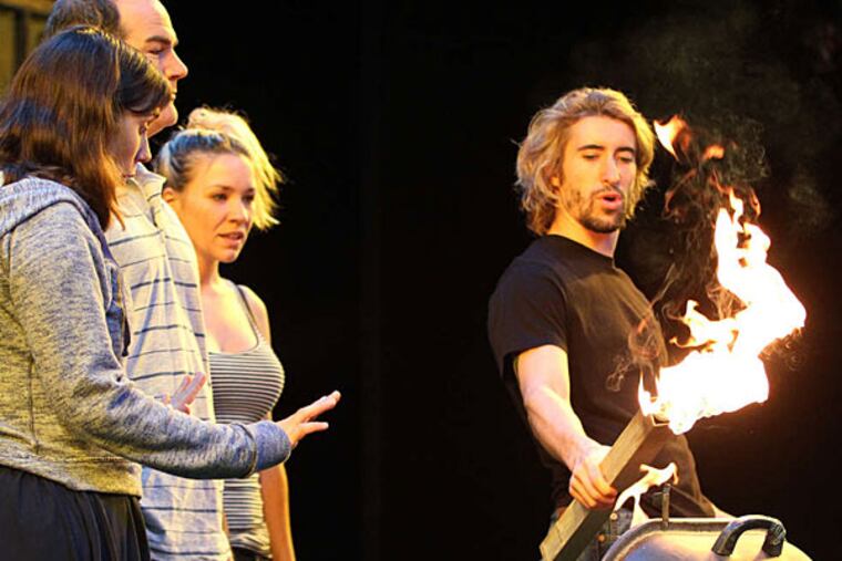 Matteo Scammell (right) as Kenny lights a fire that leads to dire consequences in the Phila. Theatre Company production of "Detroit." (MICHAEL BRYANT / Staff Photographer)