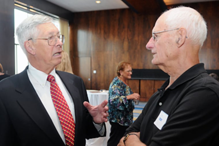 Frank Slattery (left), who has spearheaded a nearly 20-year effort to win compensation for PSFS shareholders, talks with Jack Winner at a reunion of former employees held at the Loews Philadelphia Hotel on Market Street. (Sarah J. Glover / Staff Photographer)