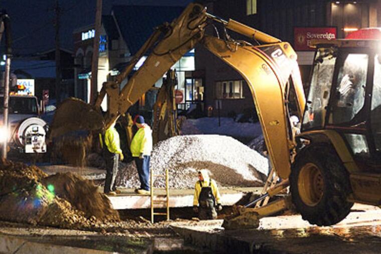 Workers dig out a hole where water from a broken pipe caused a sinkhole to form beneath northbound Route 202 in front of the King of Prussia Mall. (Kriston J. Bethel / For the Daily News)