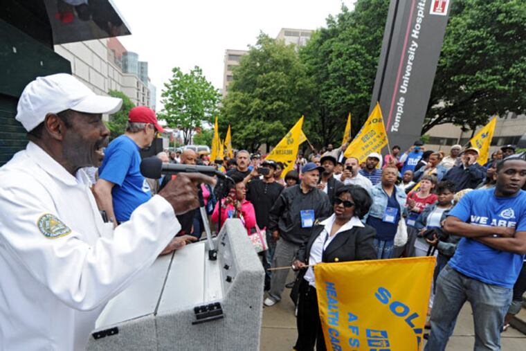 Henry Nicholas, president of District Council 1199C, addresses some of his members at a protest outside Temple University Hospital on Sunday over the hospital's appeal of an arbitrator's ruling that an employee accused of sexual harassment should be reinstated. (CLEM MURRAY / Staff Photographer)