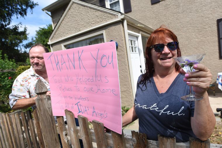 Port Providence residents Glen Murphy (left) and Gerrie Cirigliano, whose home was impacted by Hurricane Ida one year ago, hosted and toasted neighbors Saturday at the beginning of a "refreshment crawl" featuring visits to refurbished houses in the neighborhood.