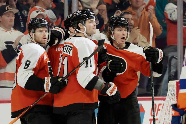 The Flyers' Trevor Zegras (right) celebrates tying the game in the third against the Islanders on Saturday.