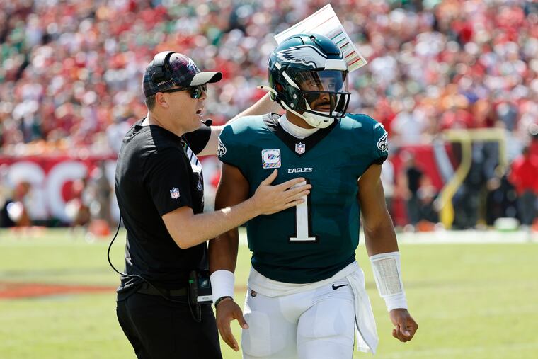 Eagles quarterback Jalen Hurts celebrates a touchdown against the Buccaneers with offensive coordinator Kellen Moore on Sunday.