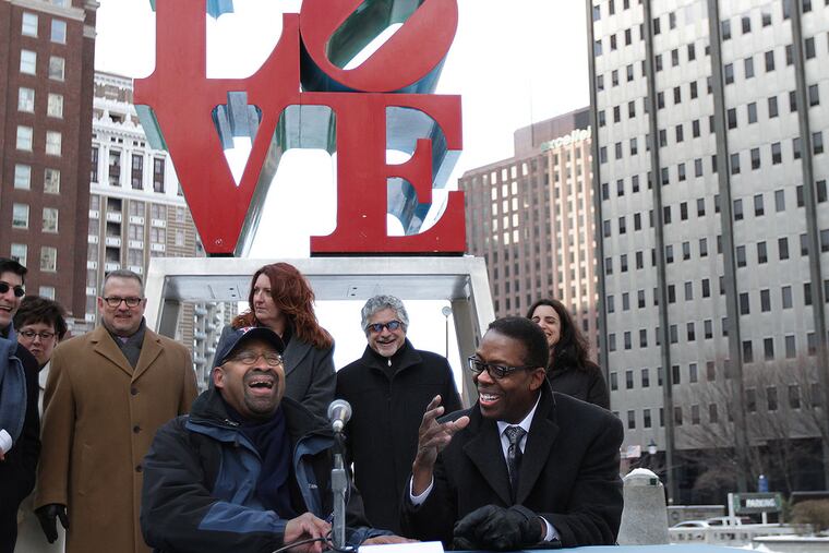Mayor Michael Nutter, left, and Council President Darrell L. Clarke, right, reached an agreement that would allow the rehab of JFK Plaza and the sale of the garage beneath LOVE Park to move ahead.Mayor Nutter laughs and Clarke said it was his worst signature because it was so cold as the two signed a document that outlined their "shared vision for LOVE Park" in Philadelphia, Pa. on February 9, 2014. ( DAVID MAIALETTI / Staff Photographer )