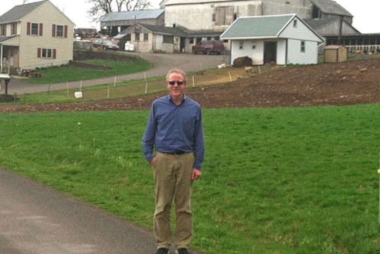 Richard Harvey, director of the Bucks County Agricultural Land Preservation Program, at a Bedminster Township dairy farm owned by Mary and Galen Leatherman, one of 150 farms preserved since the program started in 1989. (BILL REED / Staff)