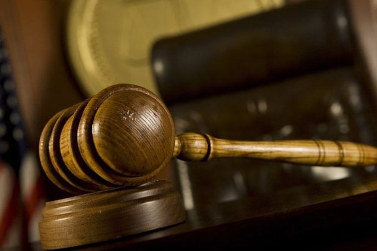 Closeup of a gavel in a court room.