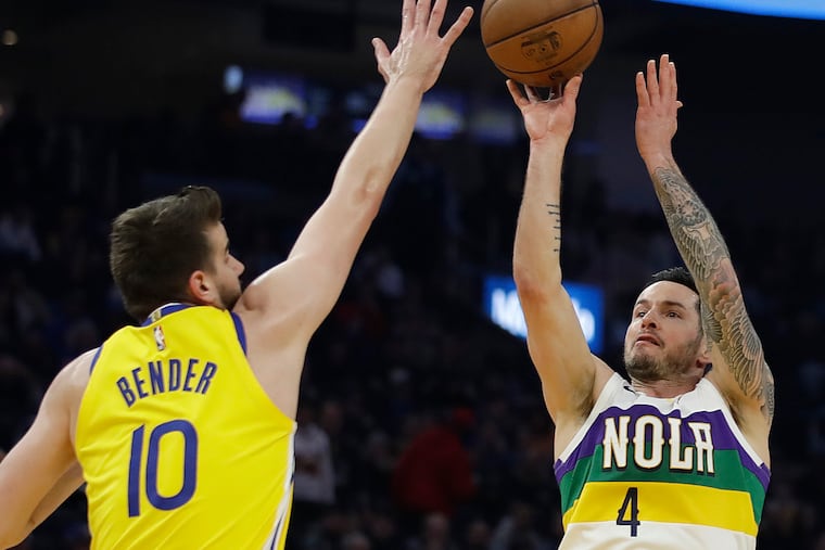 New Orleans Pelicans' JJ Redick, right, shoots against Golden State Warriors' Dragon Bender (10).
