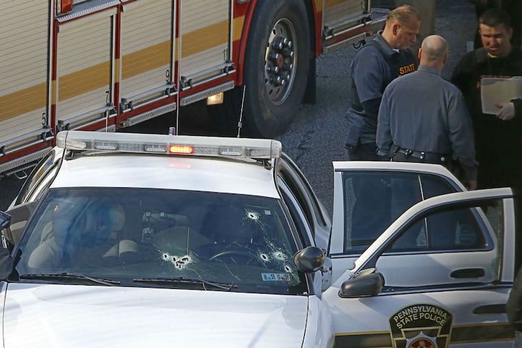 State Trooper Patrick Casey was wounded in the left shoulder during a gunfight. At least eight bullet holes were visible in the windshield of his cruiser.